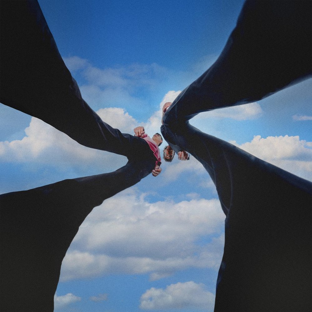 Train To Nowhere album cover: two figures seen from below, their legs forming an X against a cloudy sky